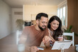 © Migma_Agency - Couple doing online shopping using tablet and credit card at home