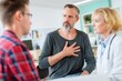 © Prazis Images - Mature man describing his heart condition to a doctor and his partner