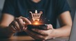 © Nilofar - A woman's hands add an item to her online shopping cart using a smartphone. A luminous orange shopping cart hologram is displayed above the device. A laptop is visible in the background.