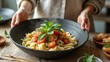 © Beniamin - Female preparing fresh italian pasta dish with tomatoes and basil