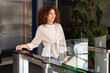© Maria Vitkovska - Businesswoman opening office turnstile using electronic key card