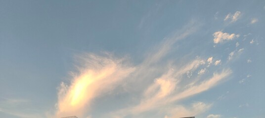 Wall Mural - twilight sky with wispy cirrus clouds in golden-blue gradient, soft translucent light.