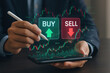 © ParinApril - Stock market trading concept with buy and sell options on digital screen held by businessman