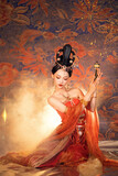 Woman in traditional attire with ornate background Chinese word means beauty.