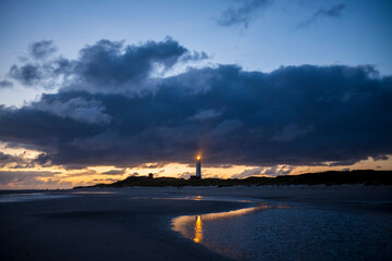 Wall Mural - lighthouse reflections after sunset