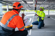 © Washburn - Technicians testing solar panel wiring underneath installation