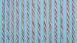© The 2R Artificiality - Evenly spaced candy canes arranged in a line on a blue surface, top-down perspective