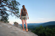 © bilanol - Hiker woman clambering on rocky mountain footpath in nature. Lonely female traveler traversing hard wilderness trail. Healthy lifestyle and sport concept