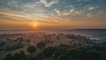 Wall Mural - Abstract natural setting featuring a textured sky at dusk with aerial view of foggy fields.