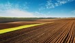 © Jessi - agricultural field tilled in spring farmland prepared for the upcoming cultivation season with copy space image place for adding text or design