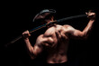 © Felix - Shirtless pirate figure holding sword over shoulder in dark studio