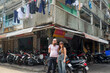 © Studio KME/Stocksy - Couple Standing in Front of Apartment Corner in Ho Chi Minh City
