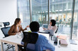 © Oleksii Syrotkin/Stocksy - Group of investors discussing projects sitting at one desk in office
