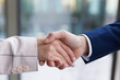 © Oleksii Syrotkin/Stocksy - Anonymous man and woman in suits shaking hands at office