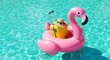 © Epep Gaming  - Summer vacation concept with pink flamingo float and yellow luggage in a swimming pool. YY 32