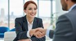 © MST - Two business professionals shaking hands in a modern office setting