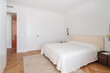 © Nibuya Qubik/Stocksy - Bright bedroom interior with white bedding and blue art