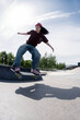 © Irina Ozhigova/Stocksy - Skateboarder performs tricks at urban skatepark during  sunny day