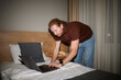 © Ivan Jovanovic/Stocksy - Busy man working on a laptop in a hotel room