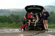 © Iuliia Versta/Stocksy - Family snack break by the forest after biking