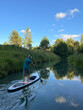 © Artem Kalashnikov/Stocksy - Man paddling upstream on green forest creek