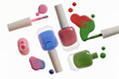 © Marc Tran/Stocksy - Vibrant nail polish bottles and spills on white background
