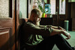 © Marko Geber - Depressed man sitting alone on floor feeling sad and stressed