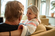 © Marko Geber - Senior couple relaxing on the couch at home smiling at each other