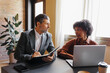 © BONNINSTUDIO/Stocksy - Lawyers working together while using laptop  in modern office