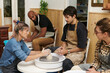 © Leire Cavia/Stocksy - Ceramist Teacher teaching their students