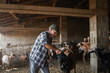 © Lupe Rodriguez/Stocksy - Ranchera with goat inside barn
