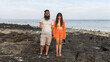 © Studio KME/Stocksy - Couple Standing on Volcanic Rocks