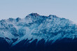 © Justin Mullet/Stocksy - Pink light on mountain peaks