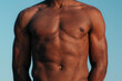 © Lucas Ottone/Stocksy - Unrecognisable athletic young black man with fit abs and torso