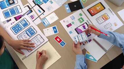 Wall Mural - top view panorama video of startup company employee planning on user interface prototype for mobile 