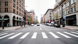 Urban street with crosswalk and parked cars on cloudy day