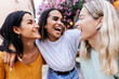 © Xavier Lorenzo - Three cheerful female friends are enjoying each other's company, laughing and having a good time on a summer day