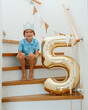 © Elena - Boy Turns Five with Golden Balloon