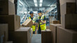 © Gorodenkoff - Caucasian Female Supervisor Using Tablet Computer To Check Inventory In Modern Logistics Facility With Conveyor Belt. Male Warehouse Worker Loading Boxes In Van For Delivering Orders To Clients.