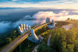 © alexkoral - Golden Bridge of the Hand of God on mountain in Da Nang in Vietnam at sunrise on a summer morning. Landscape with a top aerial view from above on famous landmark in Asia