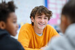 © SolaruS - Smiling teacher interacting with students. Diverse classroom scene showcasing positive relationships and education. Use for schools, learning, or youth development.