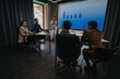 © qunica.com - Group of business people collaborating in a meeting room, analyzing data and brainstorming ideas.