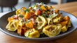 © Hashim - Homemade tortellini paired with roasted butternut squash, creating a comforting and savory dish.