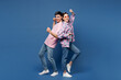 © ViDi Studio - Full body young happy couple two friends family man woman wear pink casual clothes sunglasses together doing winner gesture celebrate clench fist stand back to back isolated on plain blue background.
