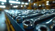 © Vitalii But - Rows of polished metal wrenches are neatly arranged on blue workbench in industrial workshop filled natural light. atmosphere is organized and productive.