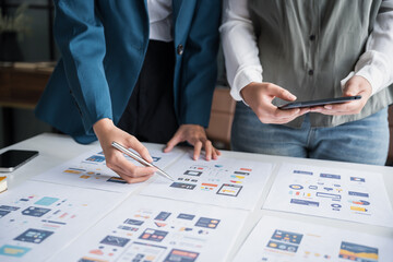 developer team brainstorming user interface and experience designs for mobile application ux ui grap