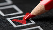 © aironamad - Close-up of a red colored pencil marking a check inside a black checkbox on white paper for task completion