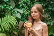 © jutaphoto - Cute little girl drinks lemonade.