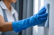 © Jay - Person cleaning surface with blue gloves and cloth