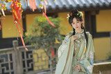 Young woman in traditional attire in a serene outdoor setting Chinese word means traditional.